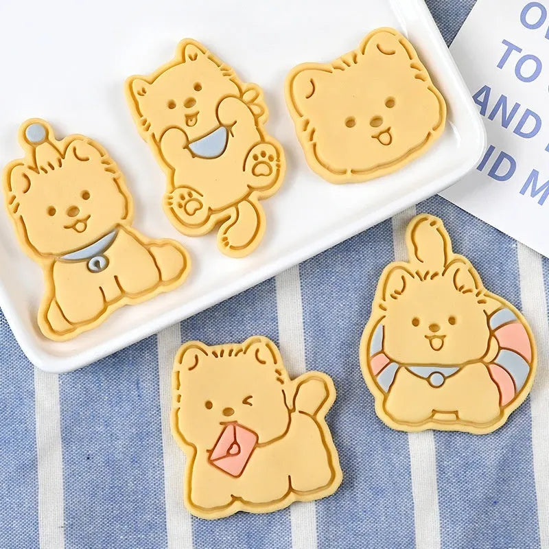 Plastic three dimensional biscuit mold with cartoon puppy designs including birthday hat style