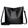 Women's soft leather bucket-style shoulder bag in black colour showing minimalist design and shoulder strap