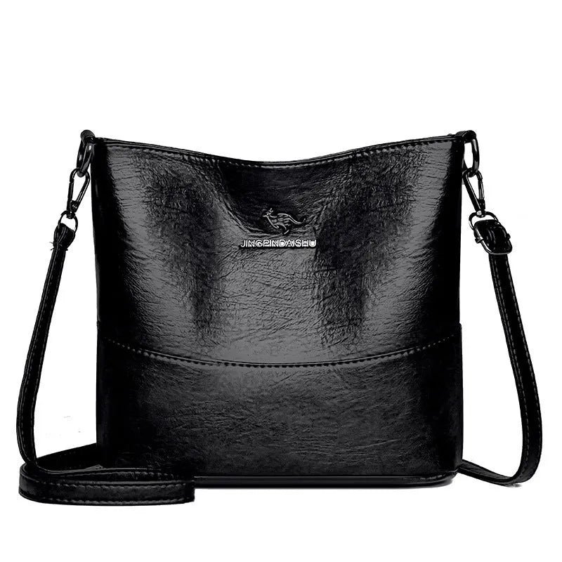 Women's soft leather bucket-style shoulder bag in black colour showing minimalist design and shoulder strap