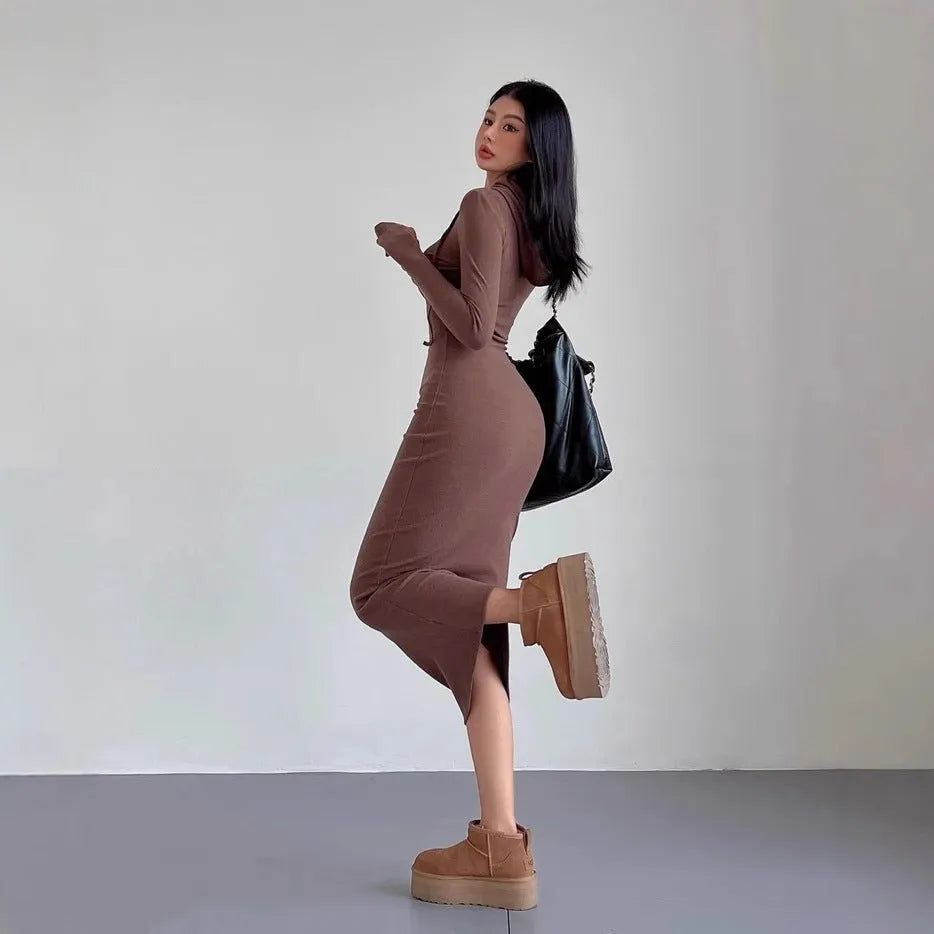 A woman's grey hooded long sleeve sheath dress with an over-the-knee length and high waist.