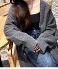 Korean style long hooded cardigan for women in oatmeal colour, showing below-the-knee length and loose fit.