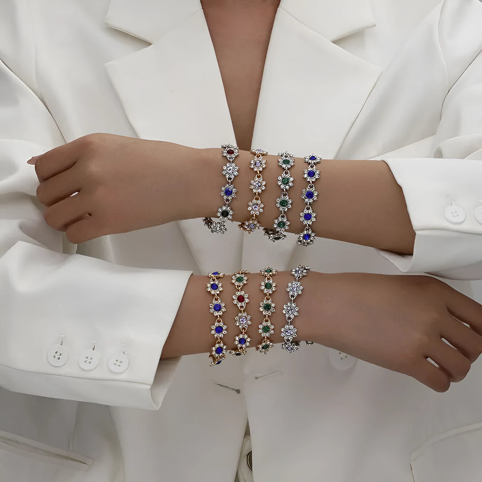 Gold and silver electroplated flower bracelets with coloured gems and crystals on a zinc alloy base.