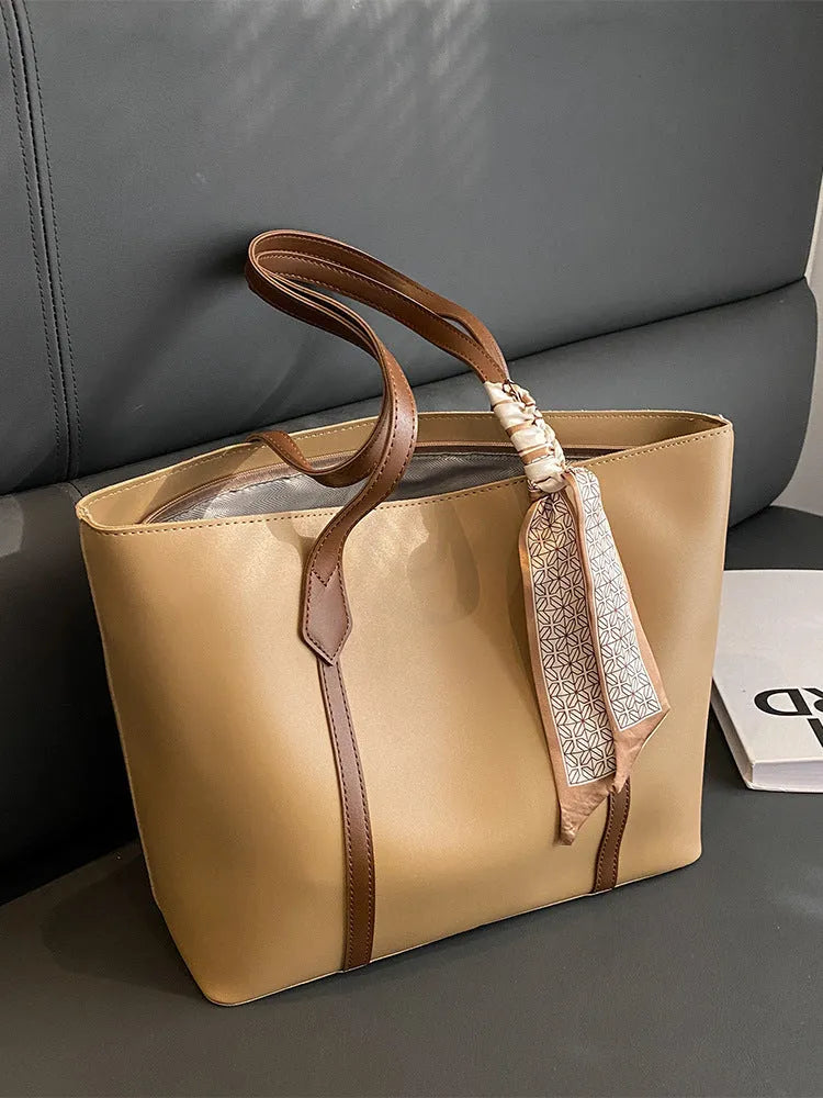 Large soft tote bag with crossbody strap shown in available colour options including black, khaki, white and pink