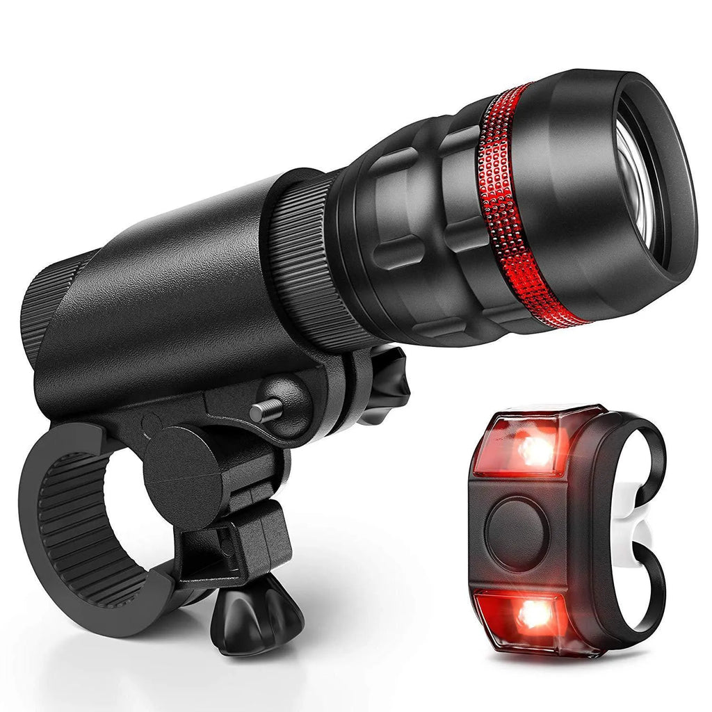 Bicycle headlights and taillights set with metal mounting bracket on a black background