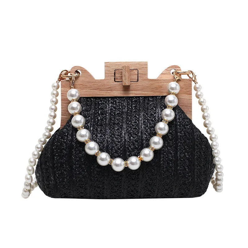 Women's woven straw shoulder bag with pearl chain detail in beige, showing horizontal square shape and single strap.