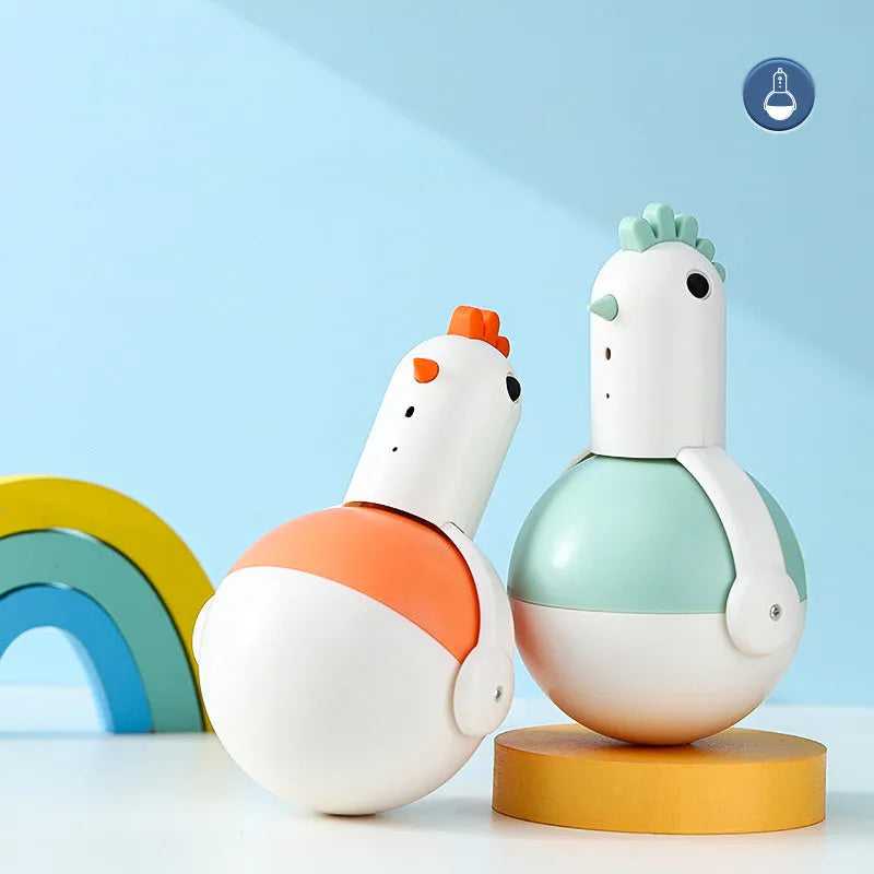 Green and orange electric cat toy chicken with laser and sound features on a flat surface.