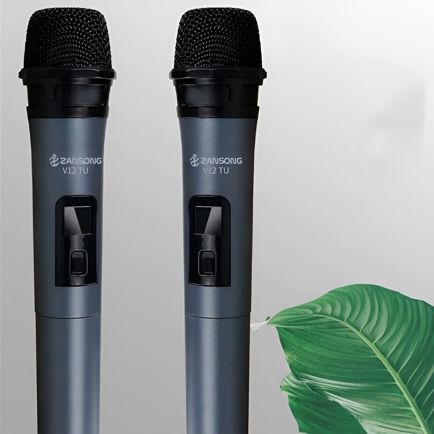 Black ZanSong V12 handheld dynamic microphone with USB receiver, audio cable, and adapter.