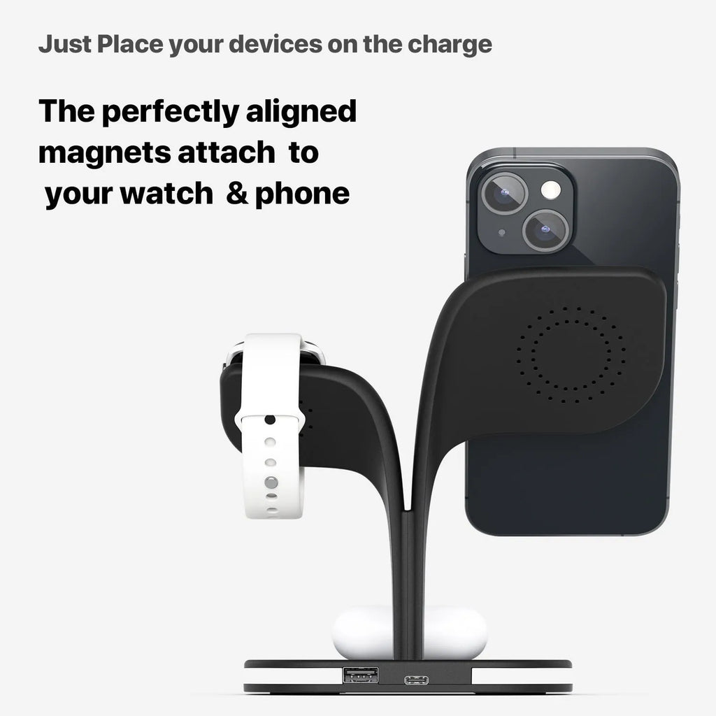 Black 3-in-1 wireless charging stand holding a mobile phone, a smartwatch, and headphones on a desk.