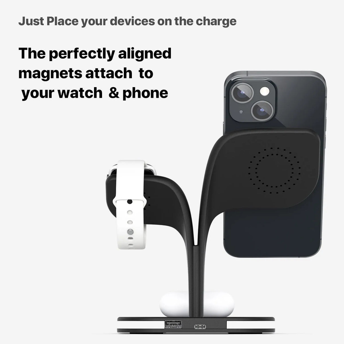 Black 3-in-1 wireless charging stand holding a mobile phone, a smartwatch, and headphones on a desk.