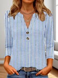 Women's loose fit V-neck top with a colourful 3D effect pattern, shown in a casual setting.