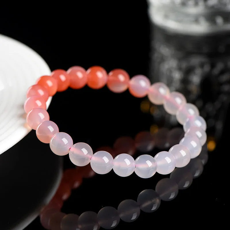 Natural gradient Yanyuan agate bracelet in geometric beads on a wrist.