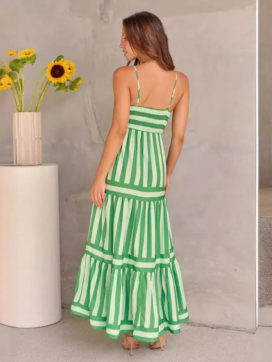Women's long striped suspender dress with an open back and pockets on a beach
