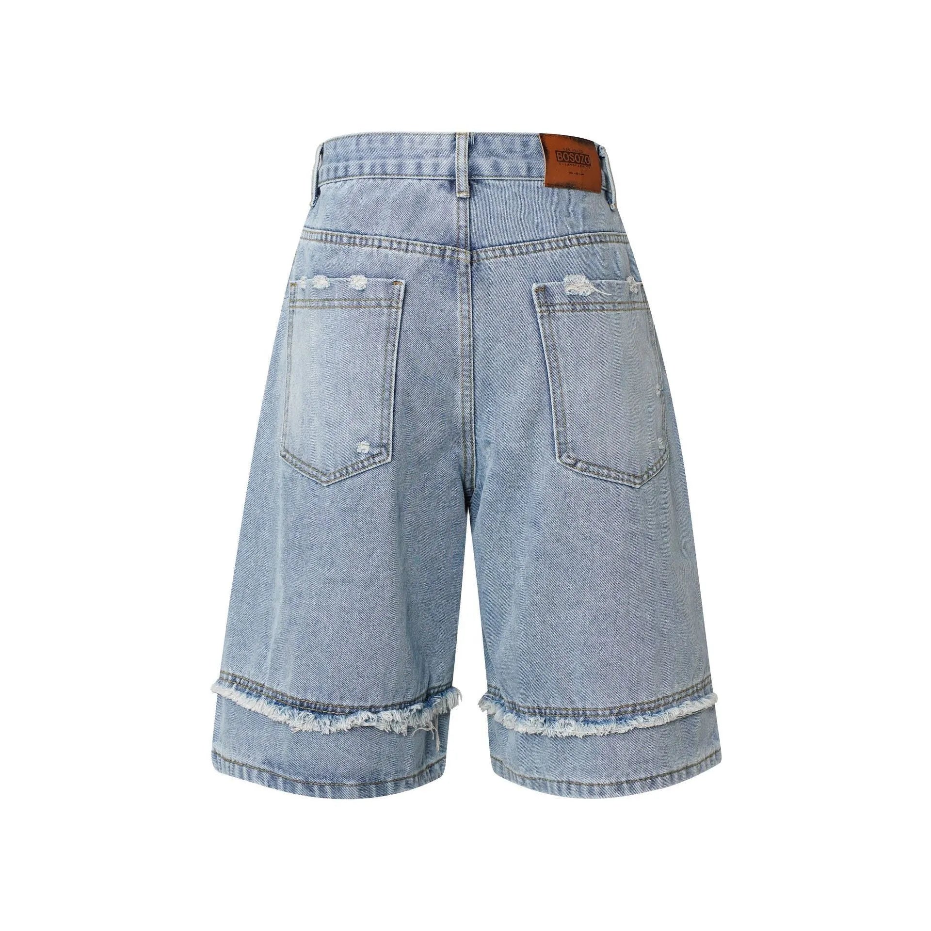 Distressed raw edge denim shorts in straight cut with cropped length for hip hop streetwear style