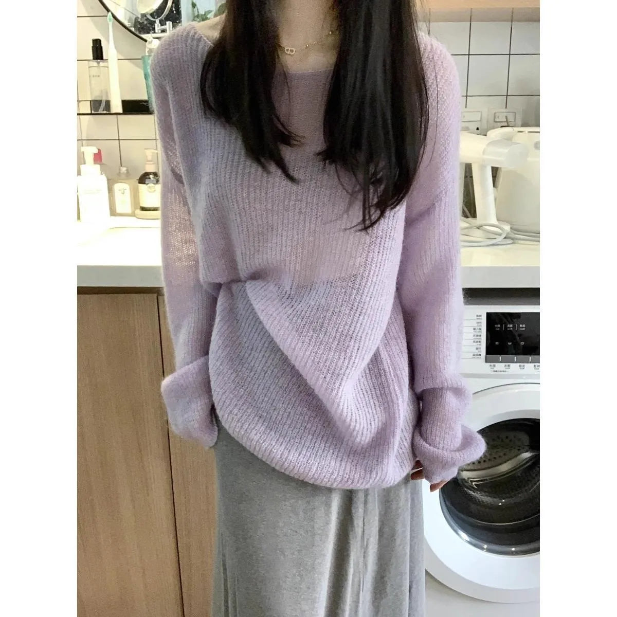 Purple women's blouse with hollow out pattern, princess sleeves, and shoulder strap detail on hanger