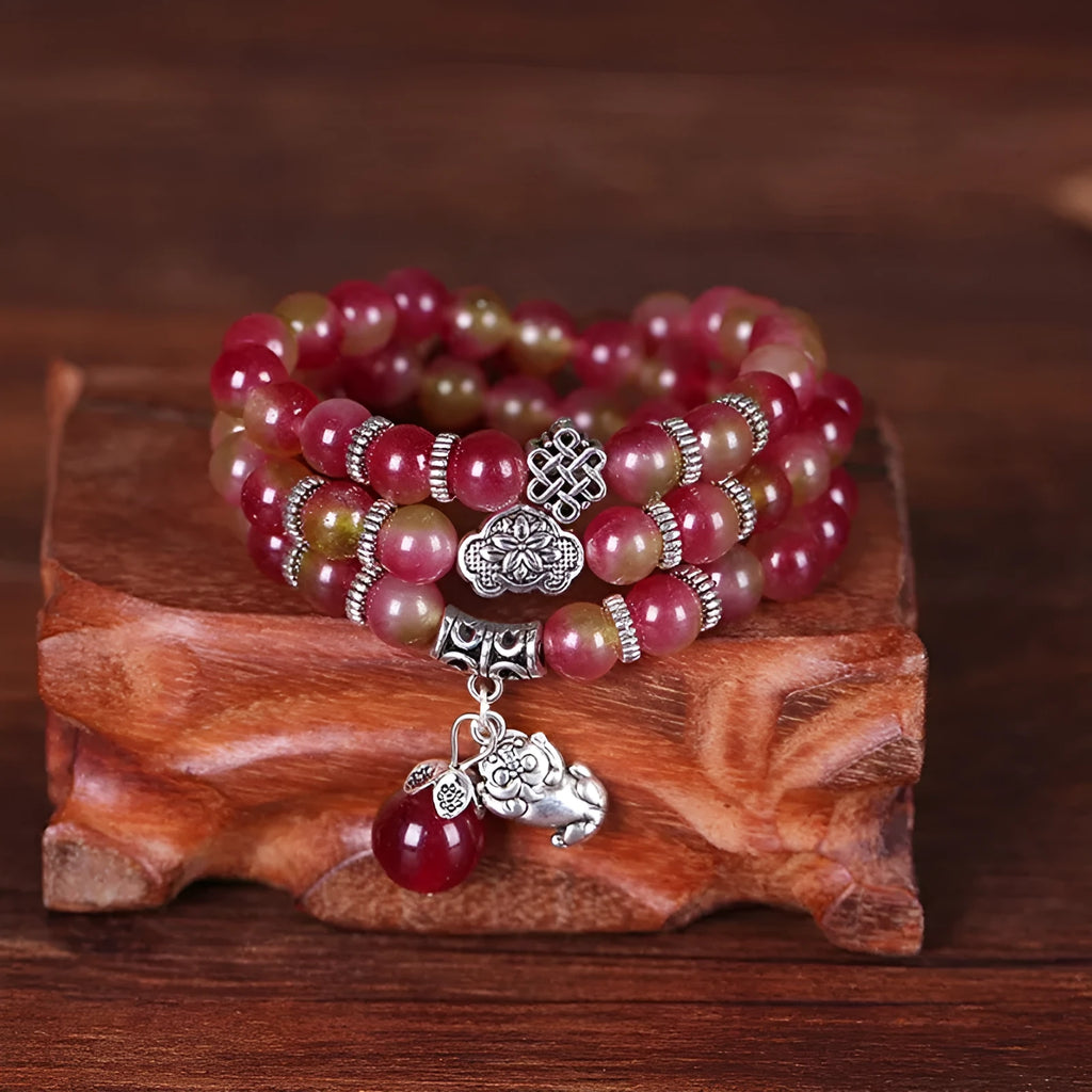 Handmade geometric bracelet made from natural watermelon crystal beads with Chinese knot closure.