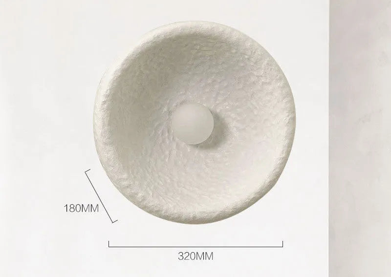 Japanese-style simple silent wall lamp with a white resin shade in three size diameters.