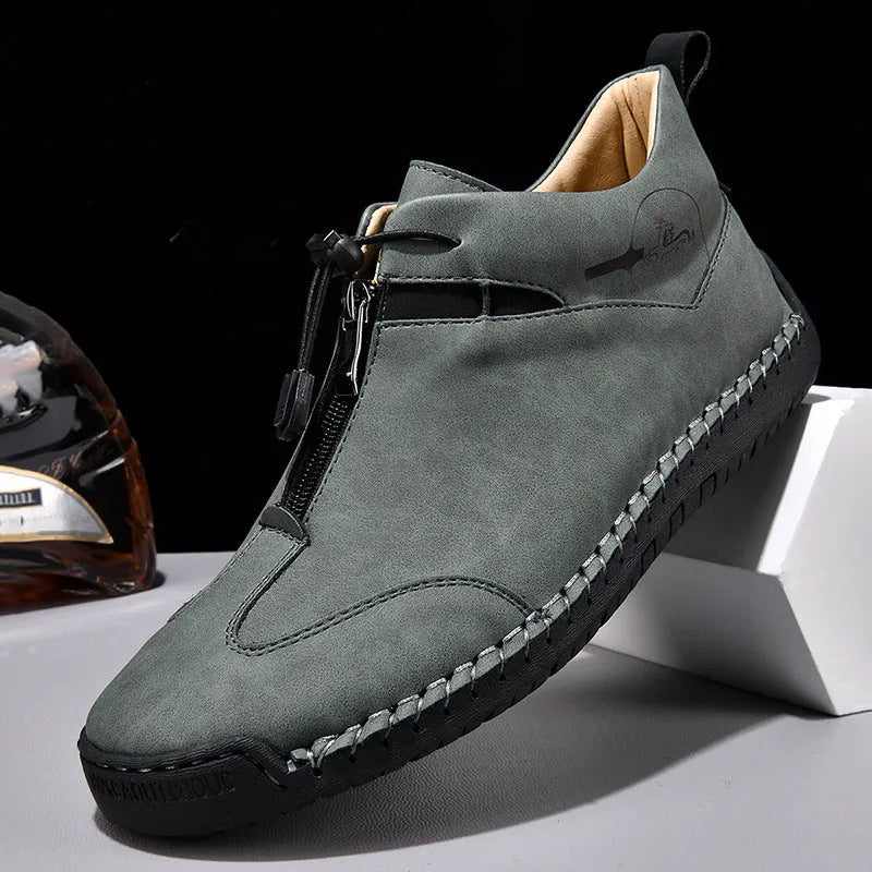 Men's black casual leather shoe with mid heel, rounded toe, and sewing thread detail on a white background.