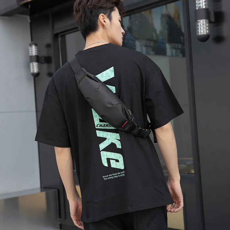 Men's black Oxford cloth crossbody waist pack showing interior organisation pockets