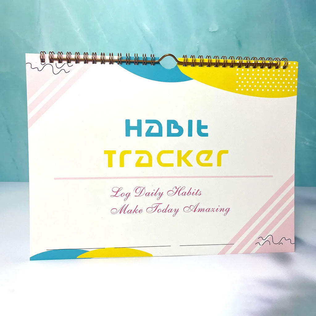 Habit tracking journal notebook open showing planning pages with colour options