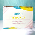 Habit tracking journal notebook open showing planning pages with colour options