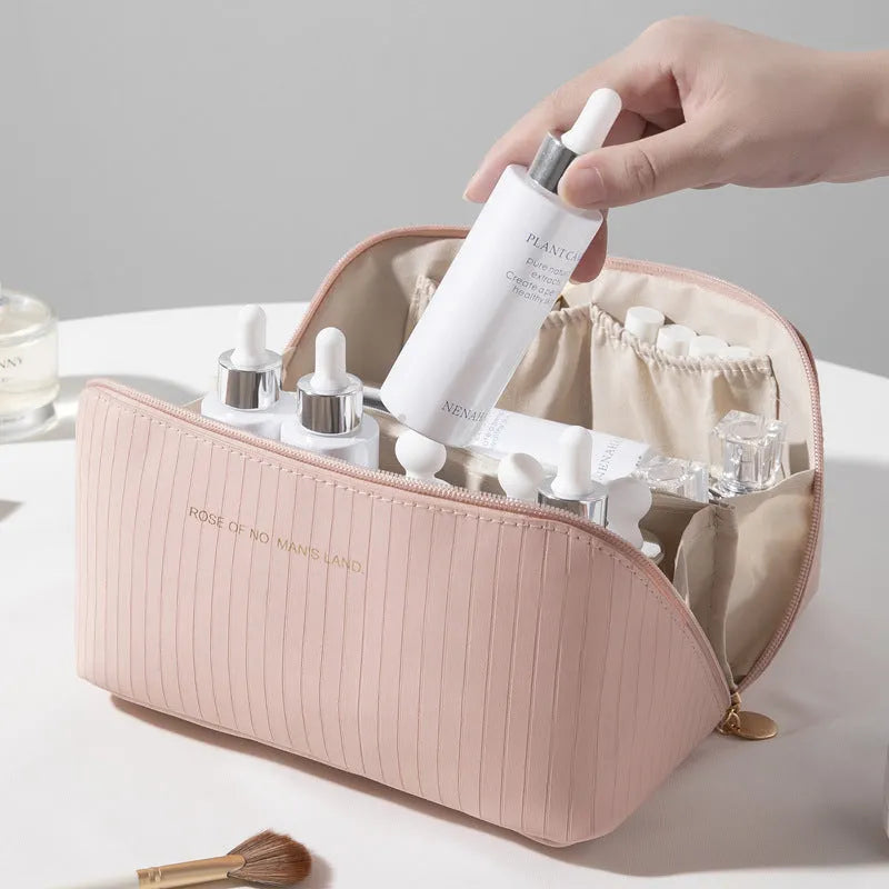 Vertical striped cubic makeup bag in beige with 22.5cm dimensions showing open interior