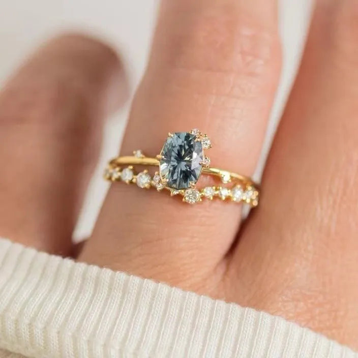 Gold plated flower-shaped ring with green zircon stone, shown in women's size.