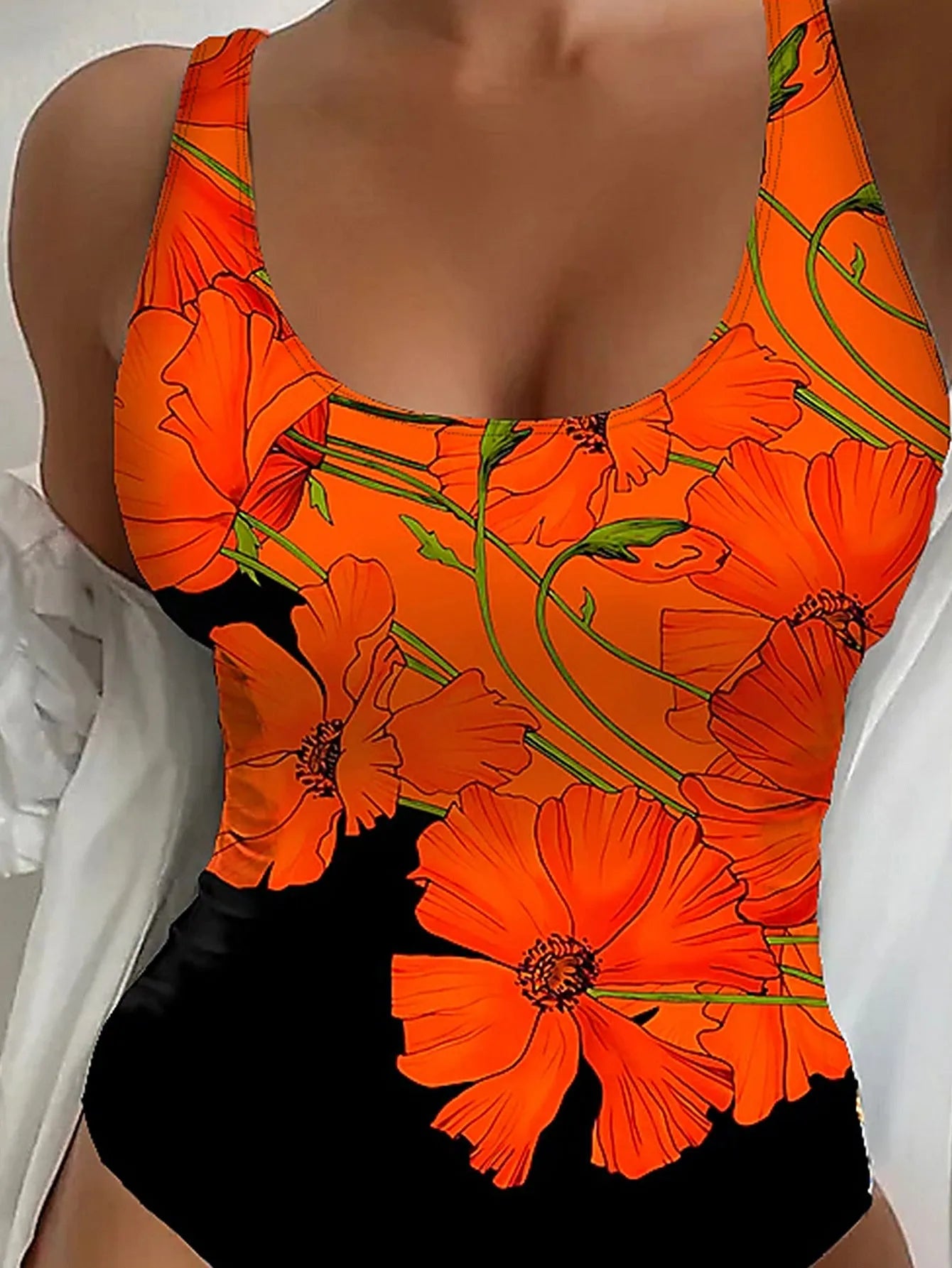 Orange floral print backless one-piece swimsuit on a mannequin.