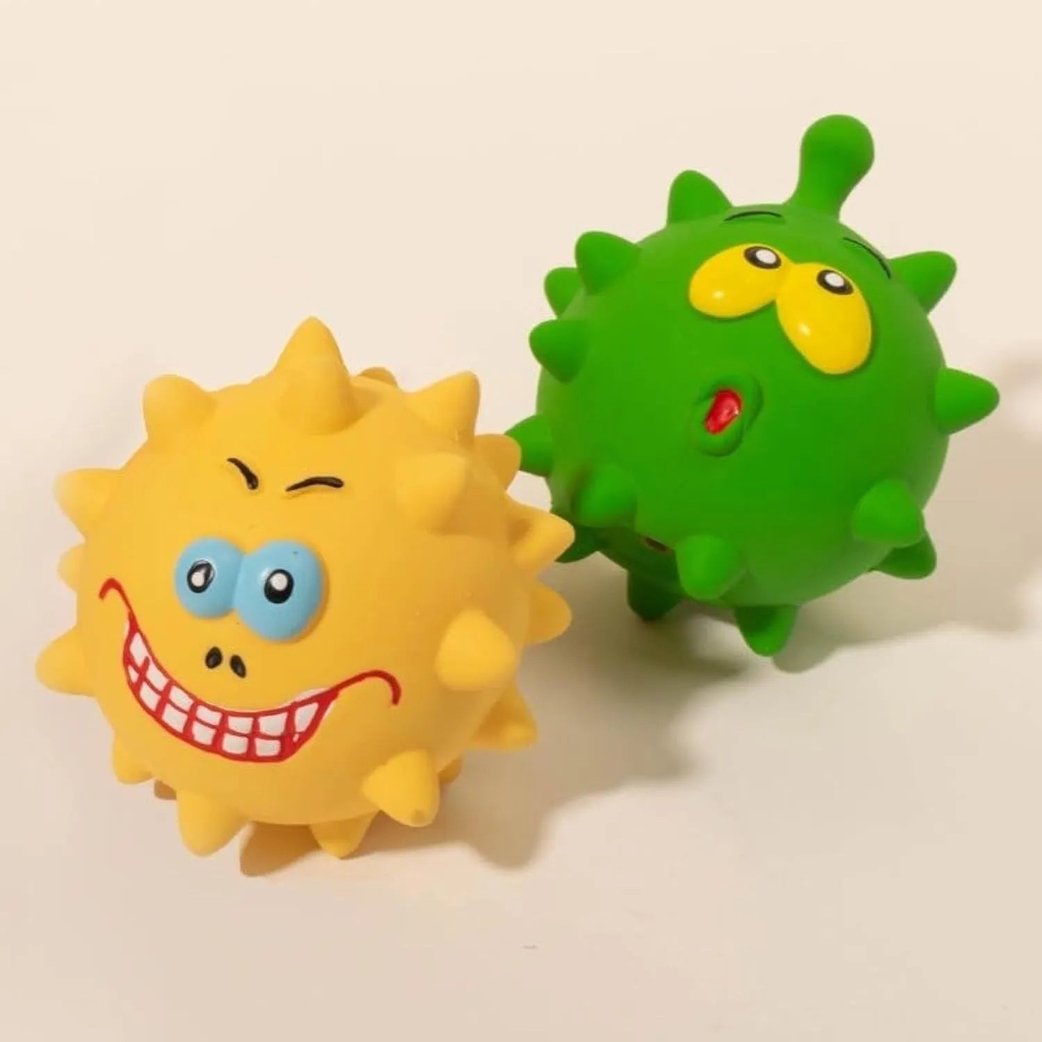 Set of four colourful natural latex rubber dog balls with cute faces and bumpy texture