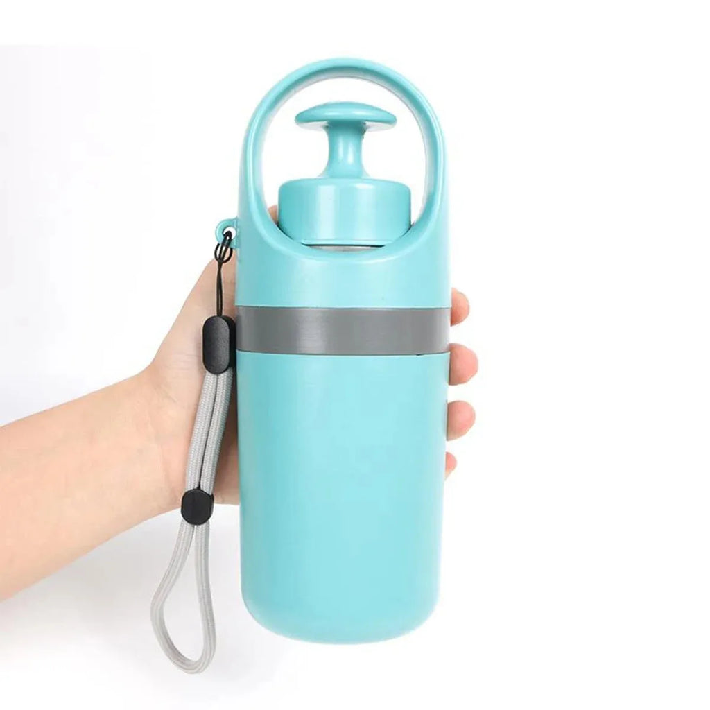 Blue pet pooper scooper claw with integrated bag dispenser for outdoor dog waste clean-up.
