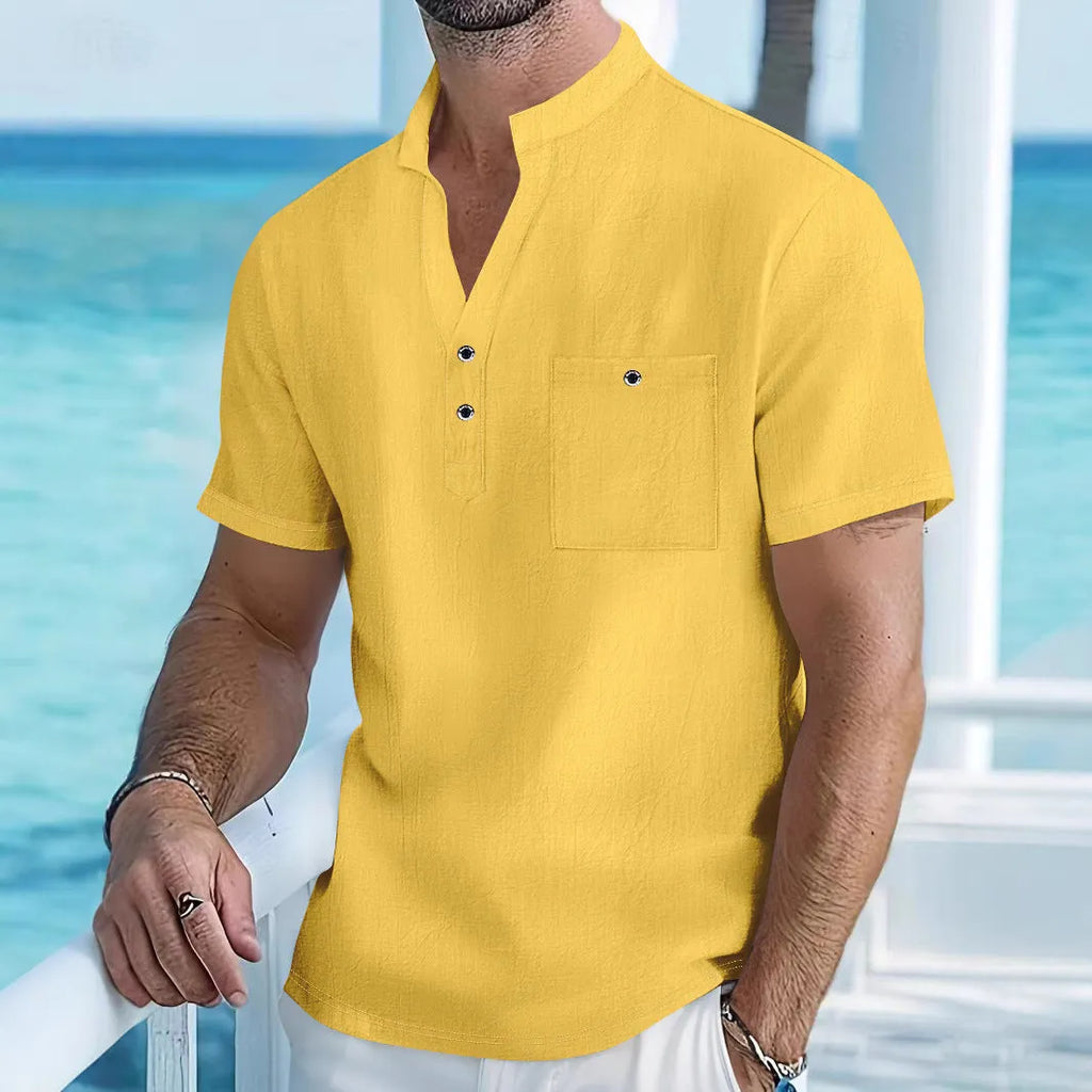 Man wearing a light blue stand collar linen short sleeve t-shirt with a loose fit.
