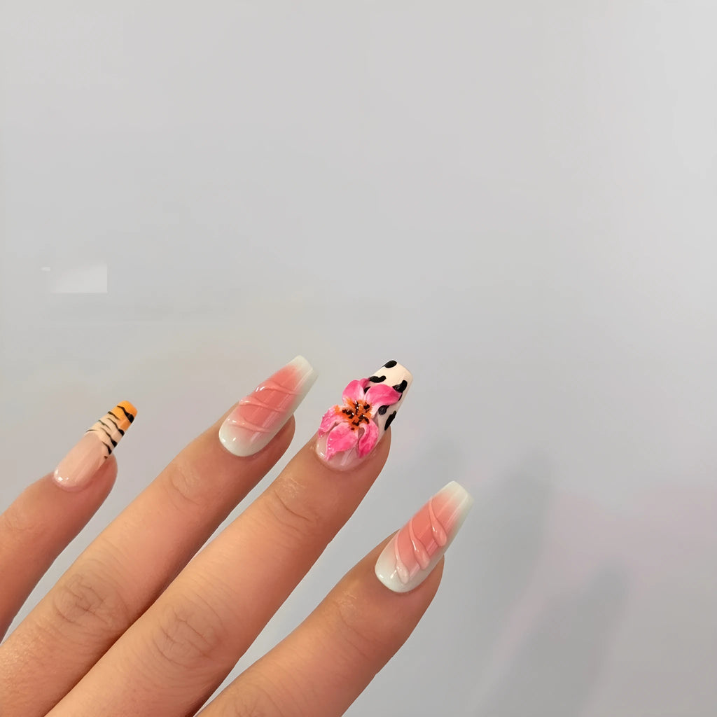 Zebra pattern and Lily hand carved nail art with flower and leopard print designs on a clear background.