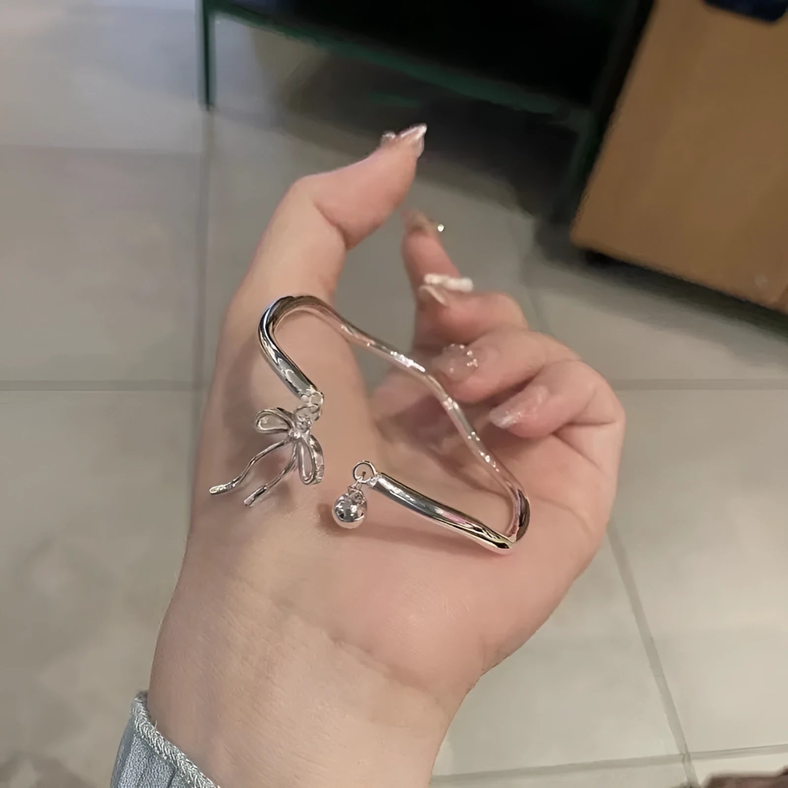 Silver adjustable bracelet with bow decoration and bell opening clasp on zinc alloy chain