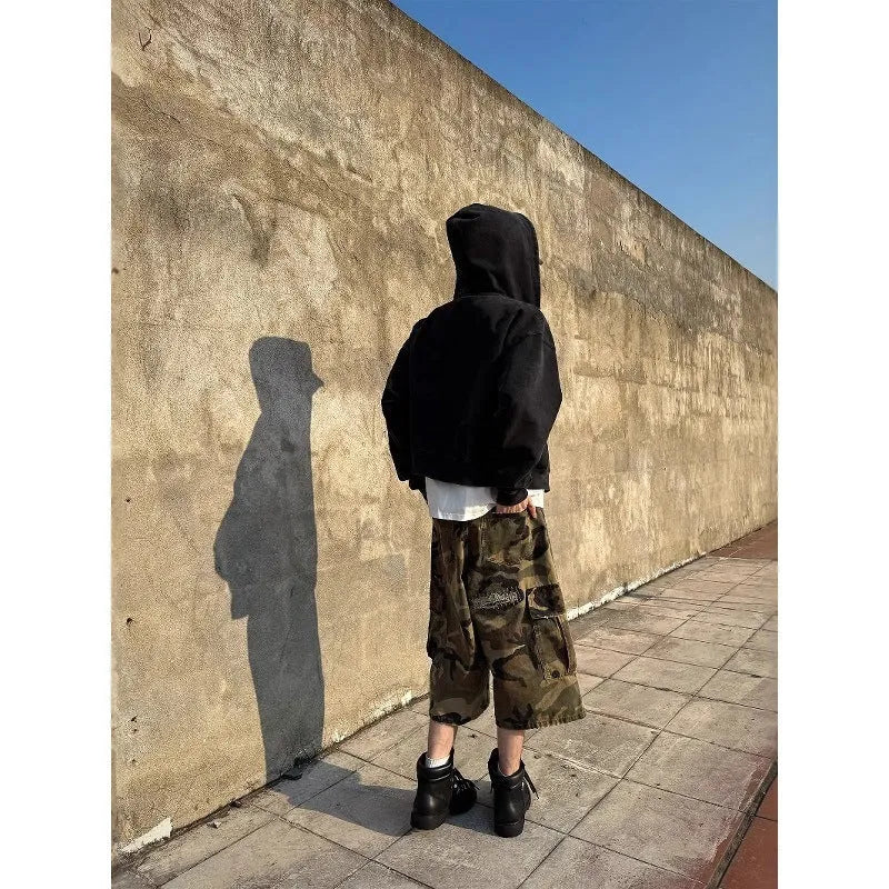 Men's camouflage coloured jeans with patchwork and ripped details, cropped length, straight loose fit.