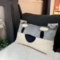 West Highland Terrier shaped decorative cushion pillow on a sofa.