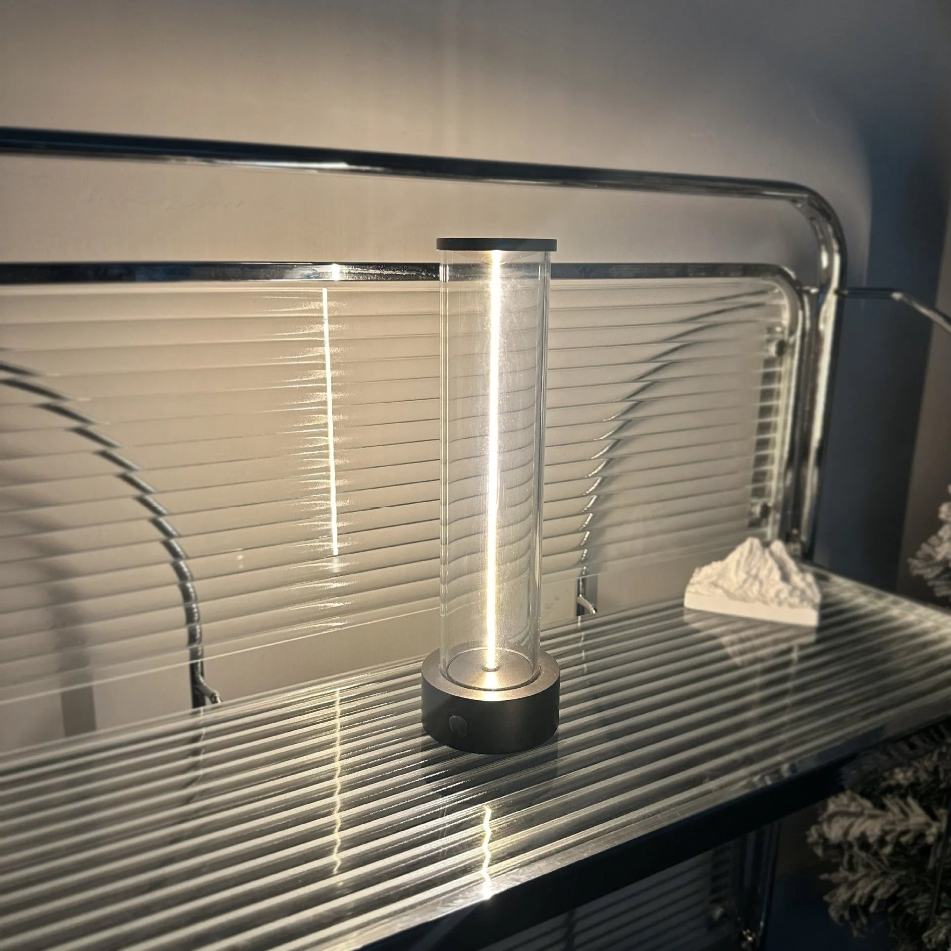 Modern glass LED light strip with magnetic back, measuring 234mm high, on a metal surface.