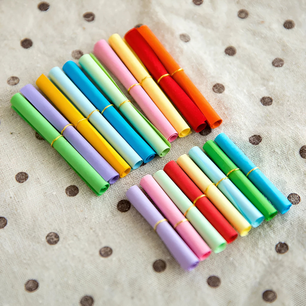 Assorted colour mini paper scrolls with eyelets for drift bottle messages and crafts.