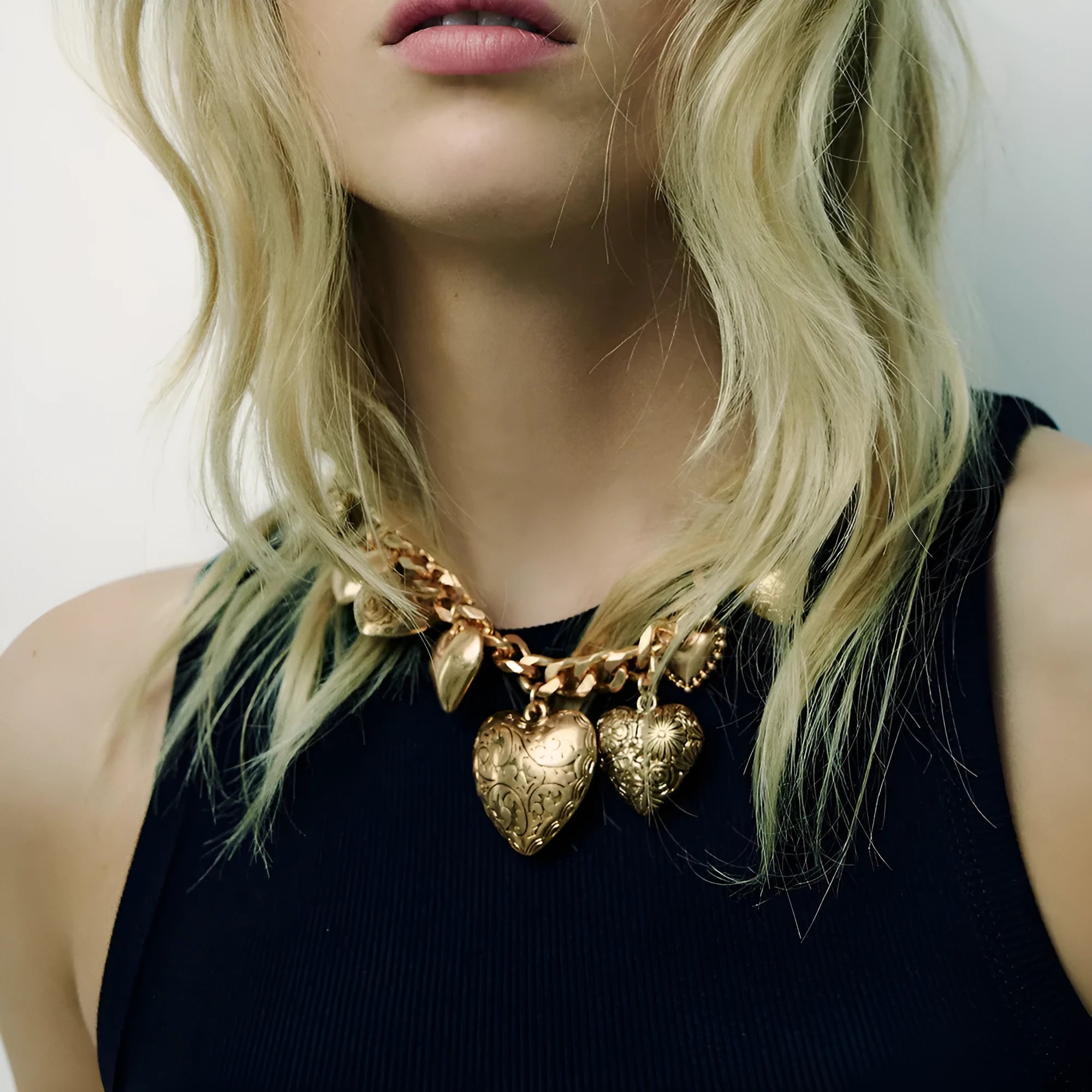 Exaggerated style carved heart pendant necklace for women in gold or white K on a regular chain.