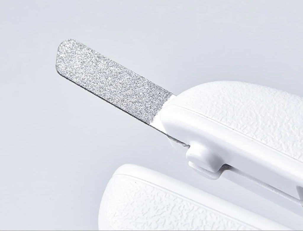 White pet nail clippers with LED light, transparent anti-splash guard, and integrated nail file on a grey background.