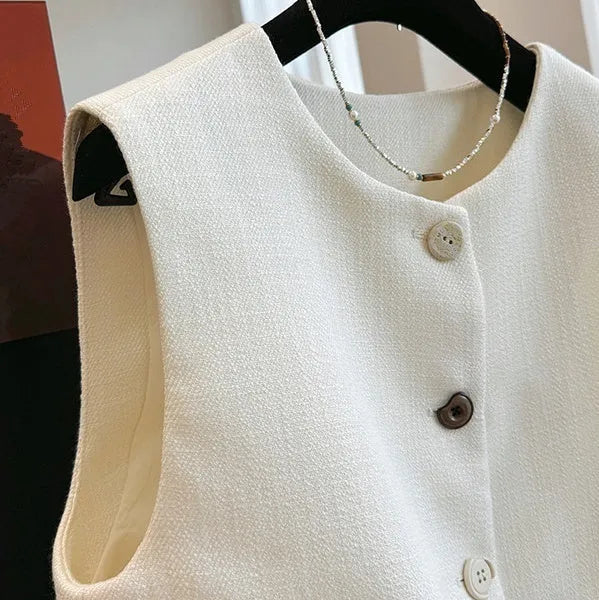Women's round neck sleeveless vest in milky white, French bandage style, shown front view.
