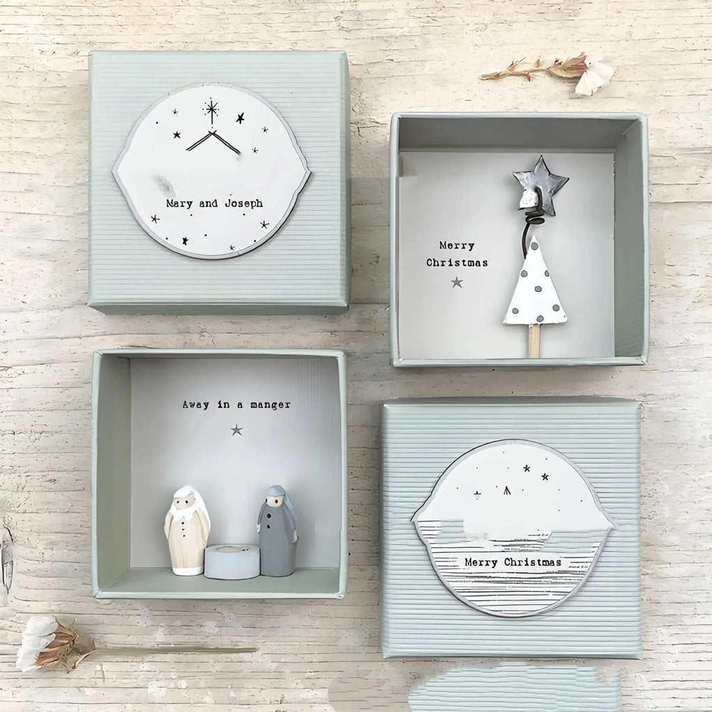 Boxed cartoon-style Guardian Angel ornament figurine on a white background.