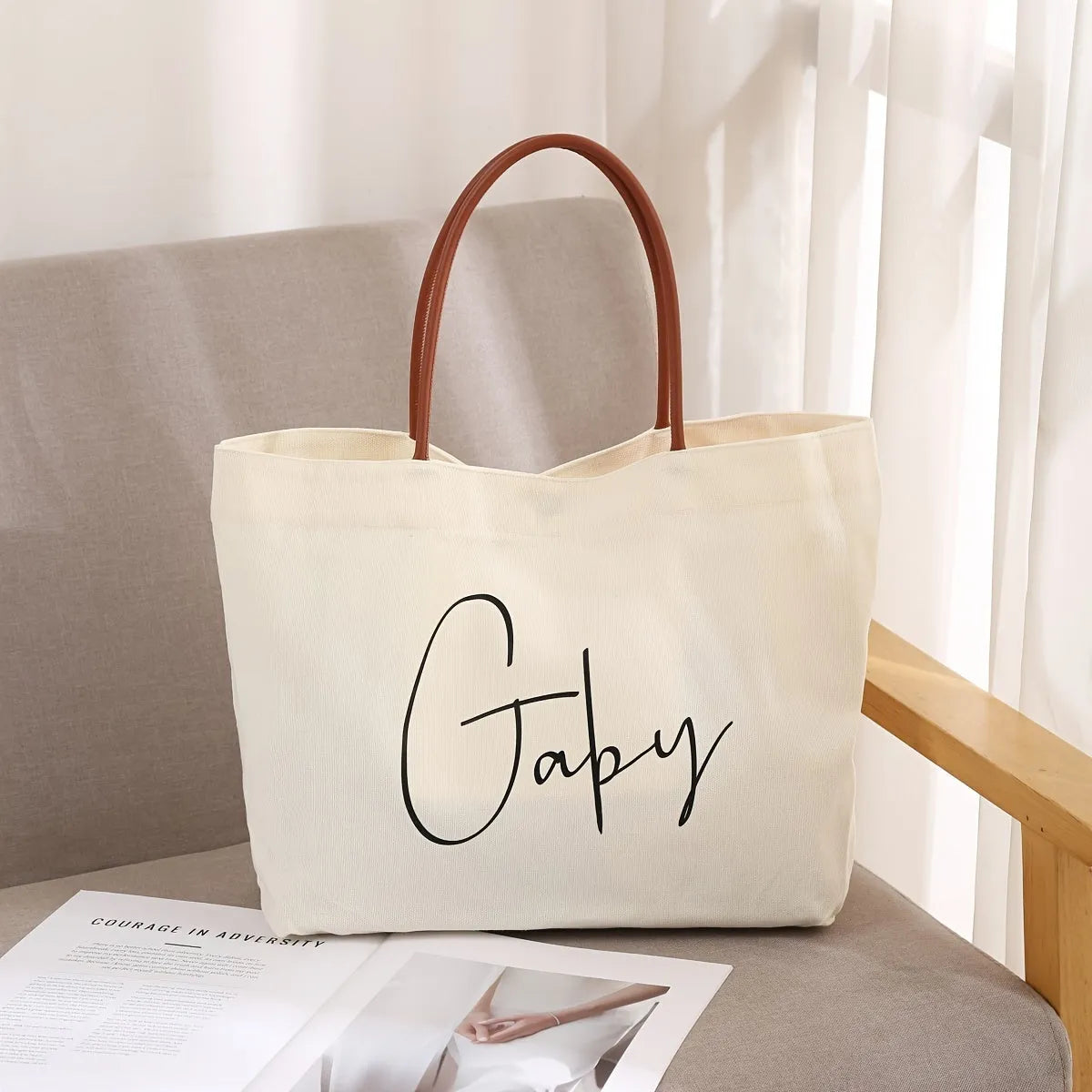 Beige white canvas tote bag with shoulder straps and front slip pockets