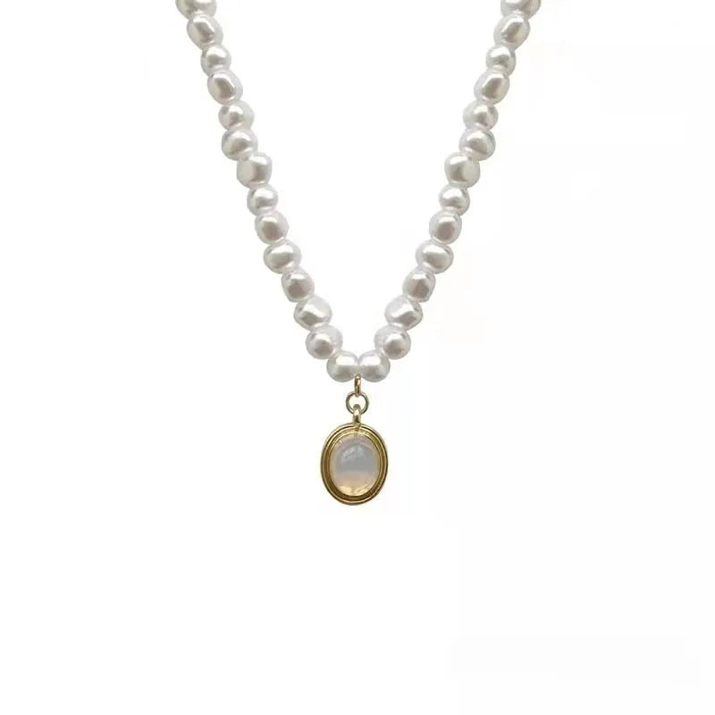 Vintage-style adjustable pearl choker necklace with a geometric alloy pendant on a silver-toned chain.