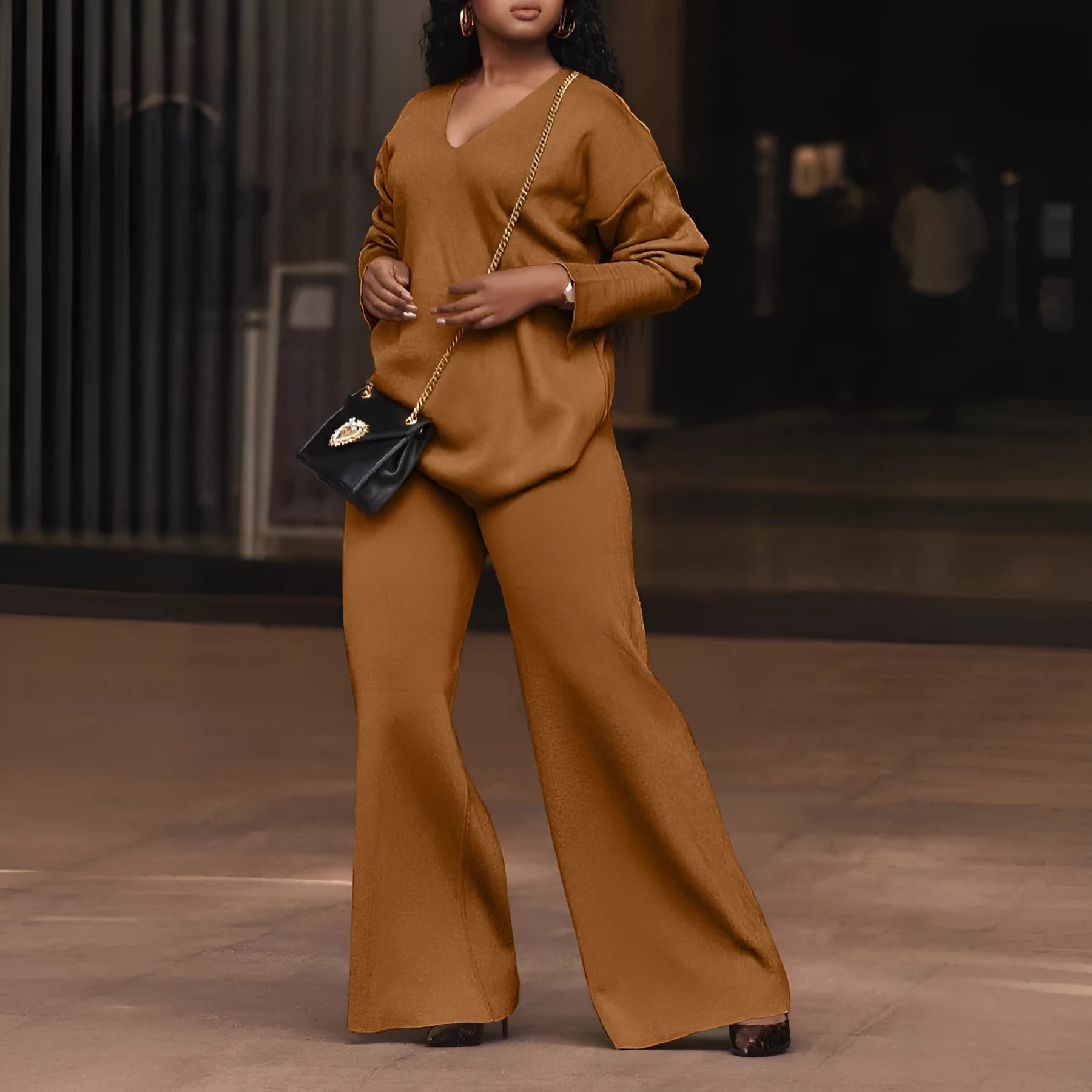Brown women's long-sleeve suede top and trousers two-piece casual suit on a hanger.