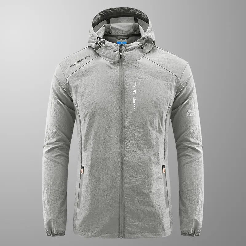Man wearing a lightweight grey hooded summer jacket made from thin nylon fabric.