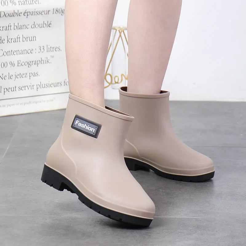 Women's mid-calf rain boot in black PVC with a low heel, shown alongside apricot and brown colour options.