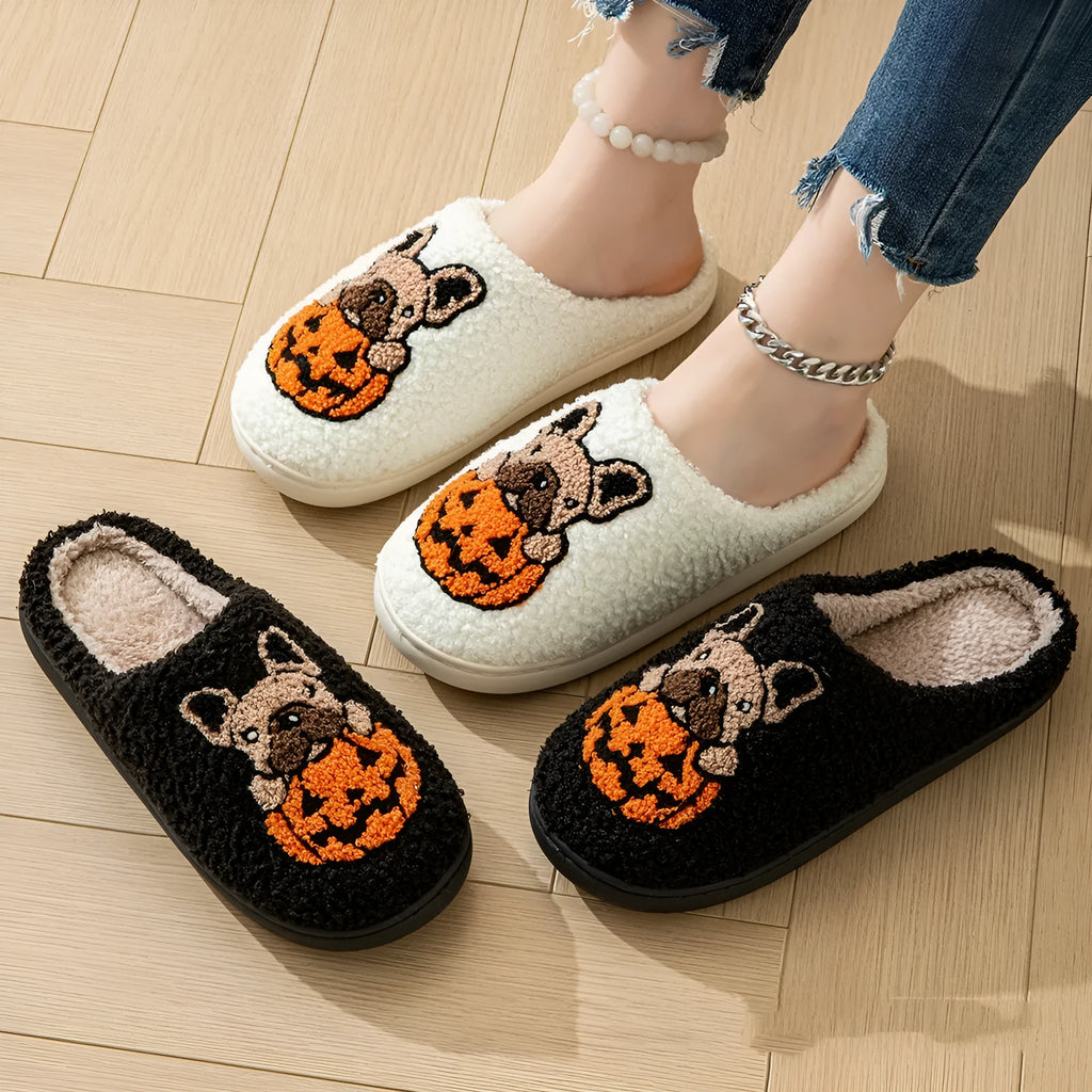 A pair of black and white Halloween-themed plush house slippers with rubber soles.