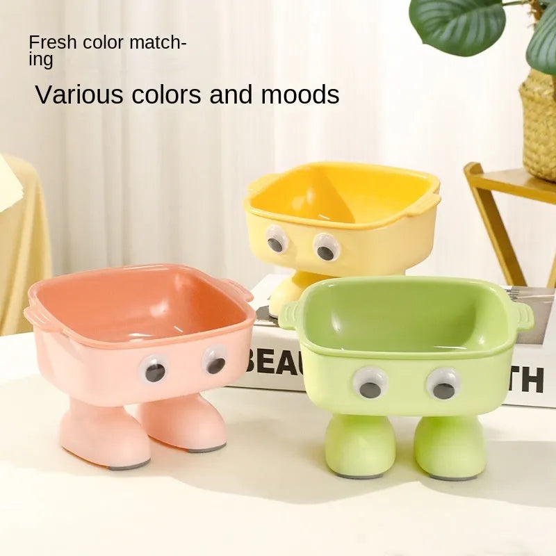 Green robot-shaped elevated cat bowl with tilted design and anti-slip base