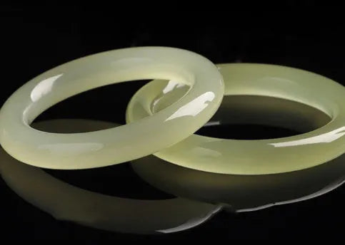 Round bar jade bracelet with geometric winding silk jade design, shown in a listed inner diameter size