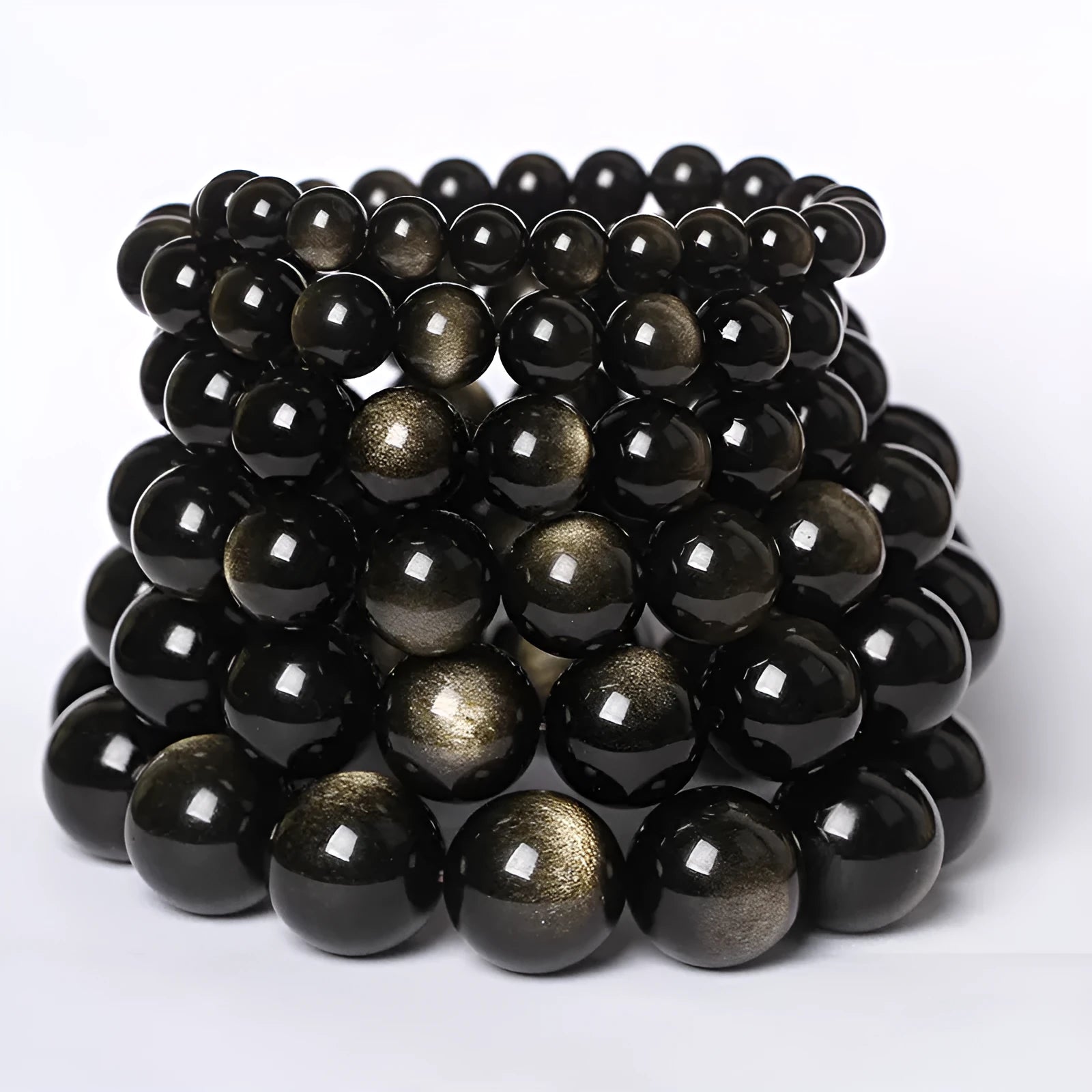 Adjustable sliding knot obsidian bracelet in hand with choice of black, rainbow eye, and silver crystal beads