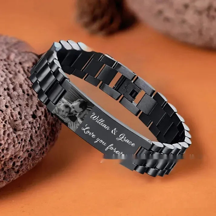 Men's curved heart-shaped stainless steel bracelet with engraved lettering, presented in a gift box.